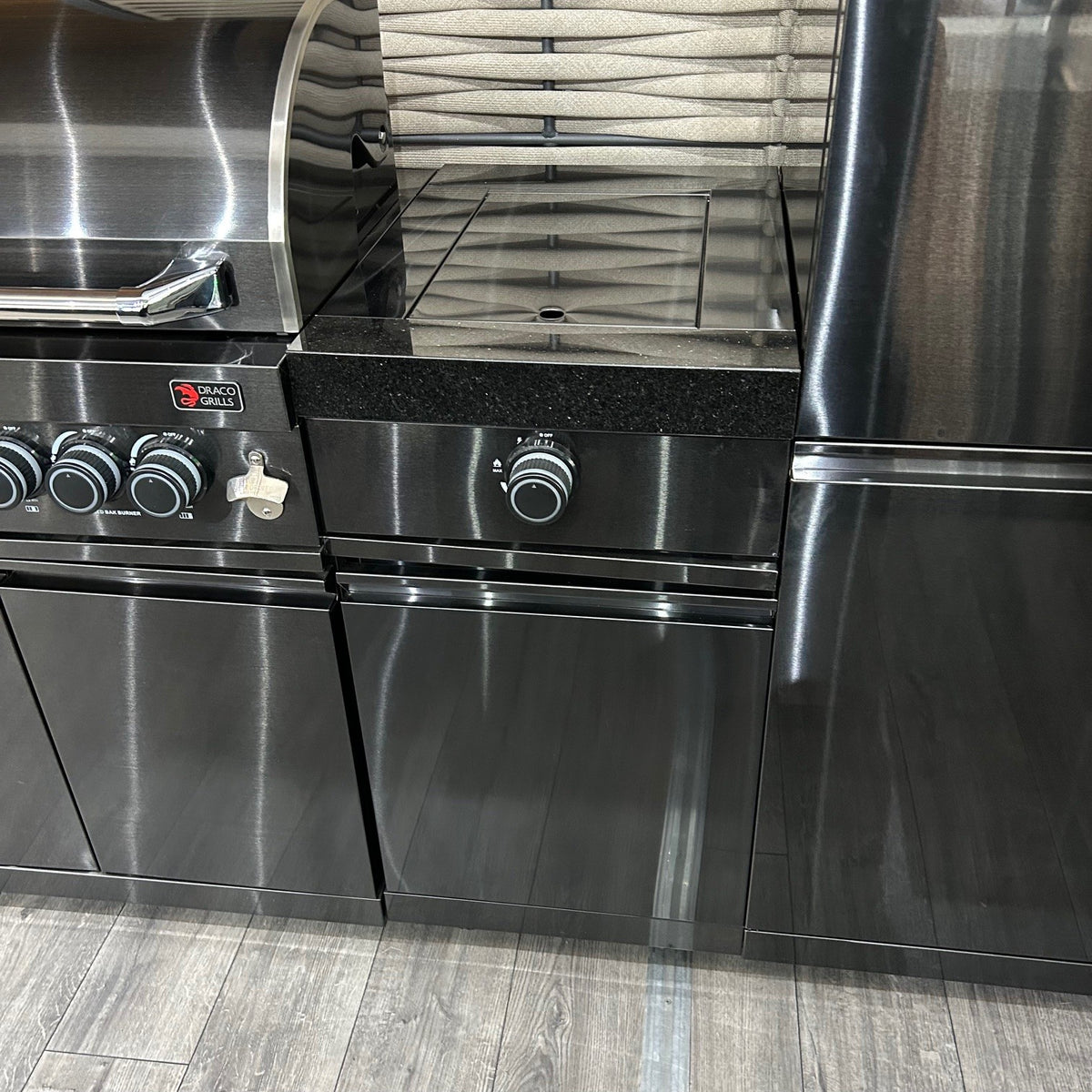 Ex Display Draco Grills 4 Burner Black Stainless Steel Outdoor Kitchen with Sear Station, 3 Drawer Unit and Mid Height Unit with Single Fridge